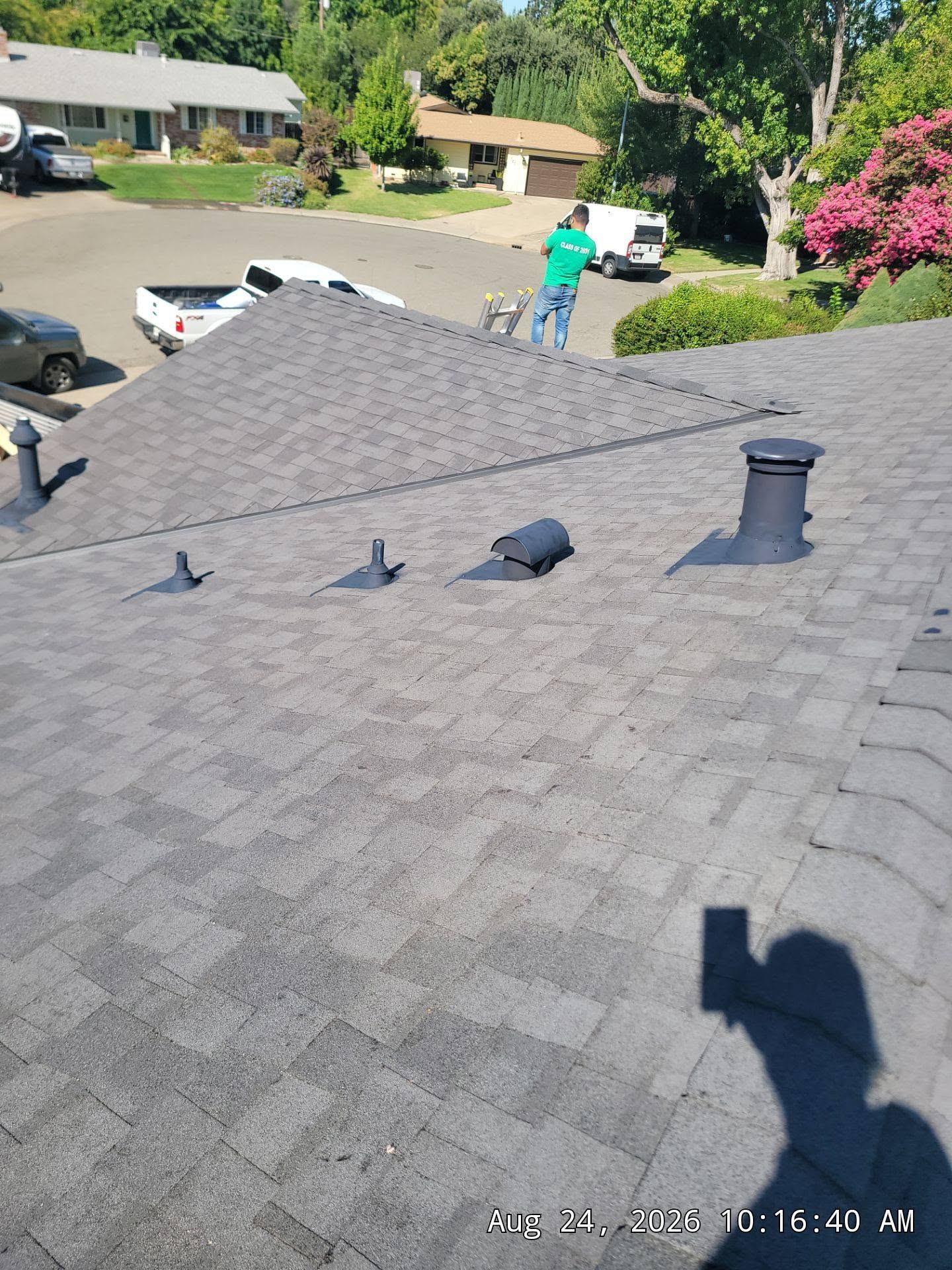 Finished composition shingle roof with vents