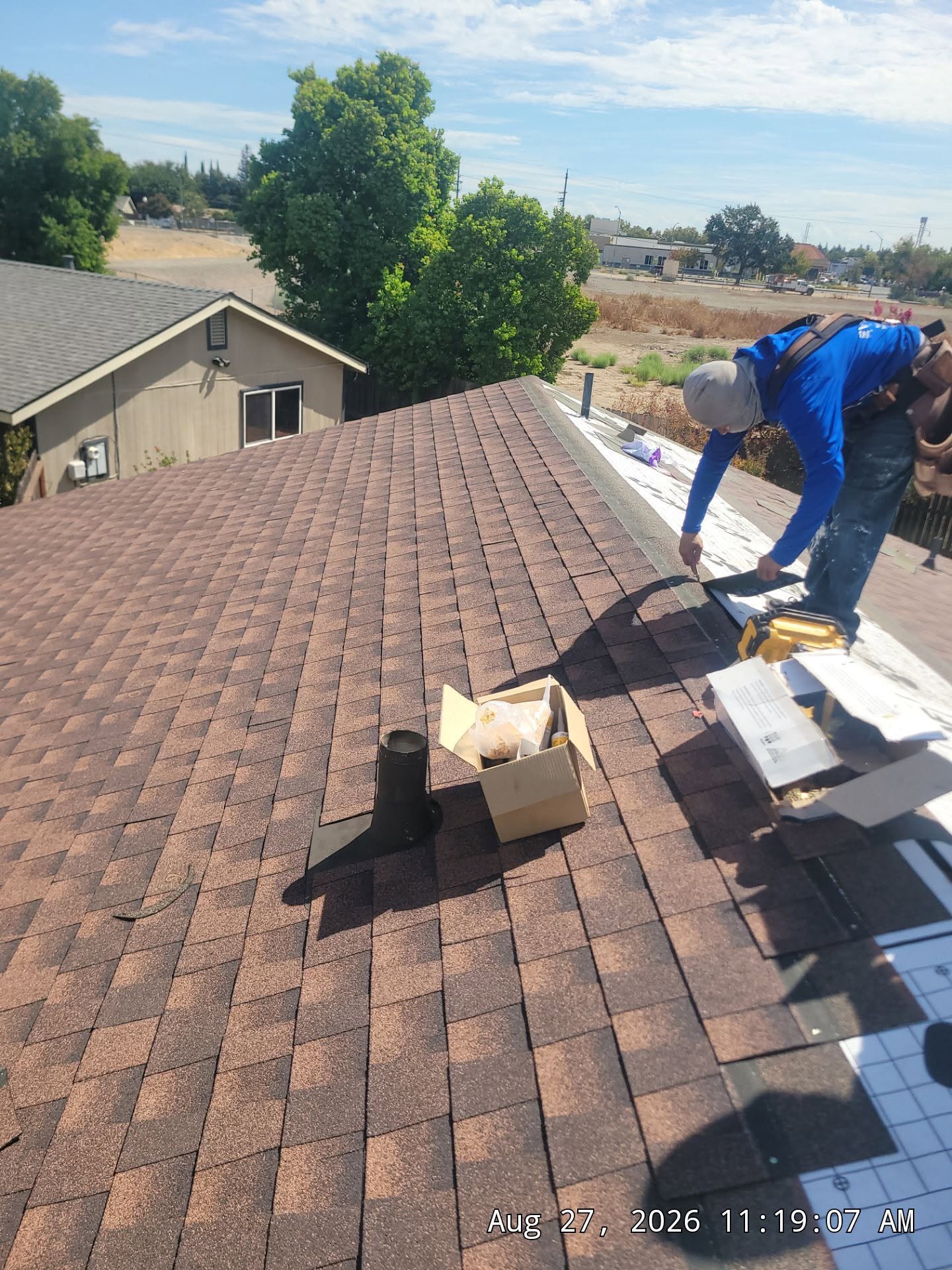 A Reynoso Roofing crew member installing shingles